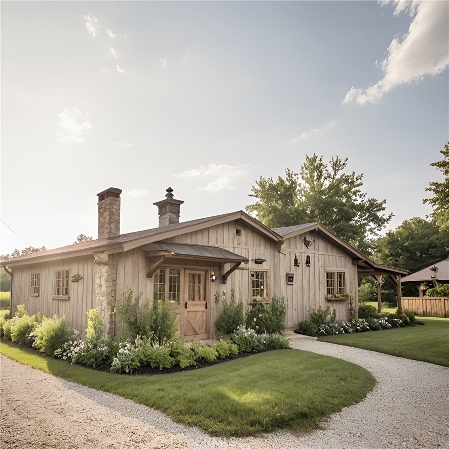 a front view of a house with a yard and potted plants