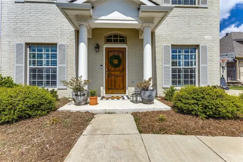 a front view of a house with outdoor seating and plants