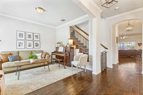 a living room with furniture and a wooden floor