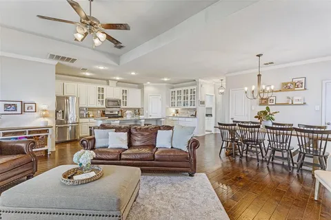a living room with lots of furniture and kitchen view