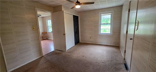 an empty room that has a mirror in it