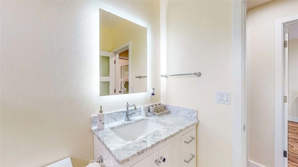 7300 Santa Susana Pass Road Simi Valley, CA 93063 - Photo 34 of 34 a bathroom with a granite countertop sink and a mirror