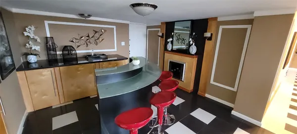 a kitchen with sink refrigerator dining table and chairs