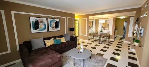 a living room with furniture a dining table and a window