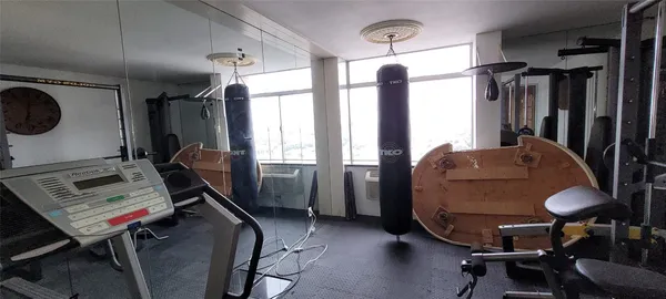 a bedroom with a bed and a mirror on dresser