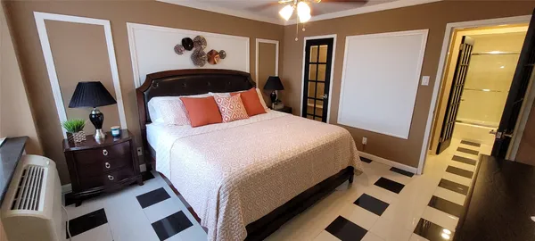 a bedroom with a bed and a chandelier