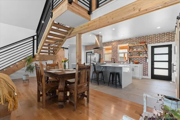 a dining hall with furniture a window and kitchen view