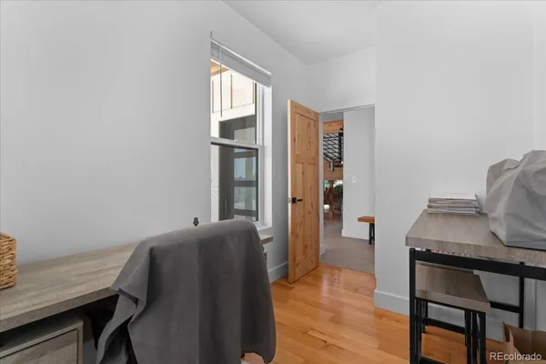 a workspace room with furniture and window