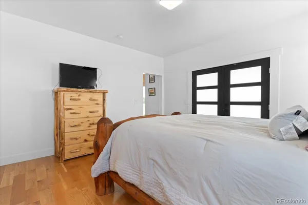 a bedroom with a bed and a flat screen tv