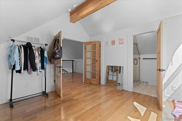 a view of walk in closet with clothes and shoes