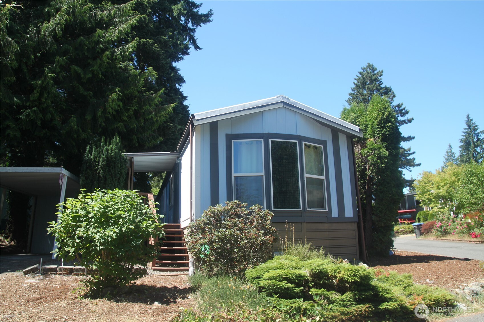 3060 Northeast McWilliams Road, Unit 9 Bremerton, WA 98311 - Photo 2 of 16 a front view of a house with garden