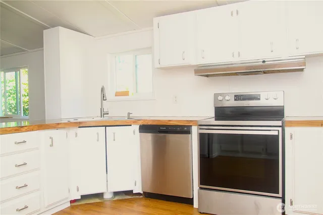 a kitchen with granite countertop a stove and a sink
