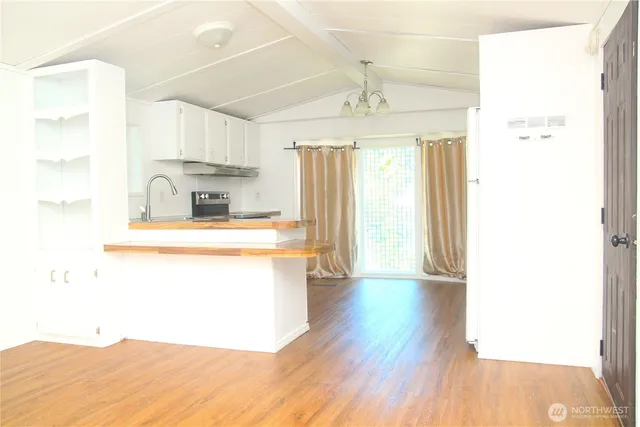 a kitchen with a refrigerator a sink and a window