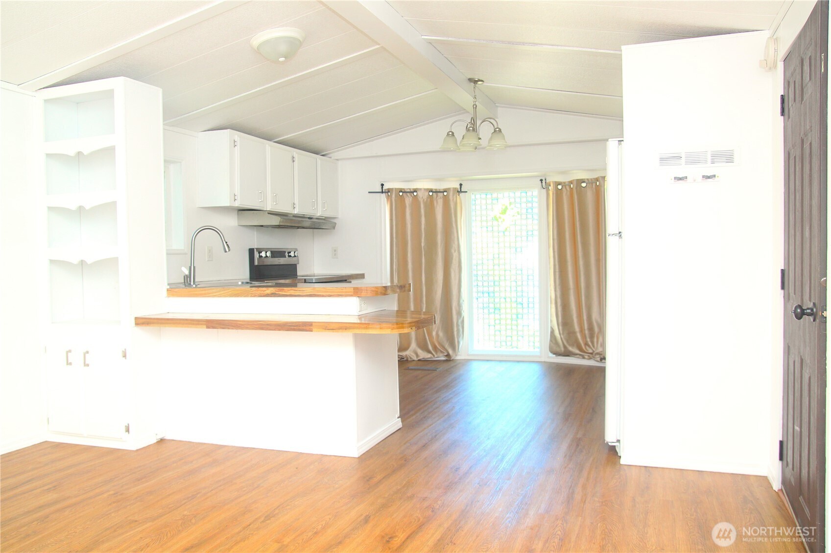 3060 Northeast McWilliams Road, Unit 9 Bremerton, WA 98311 - Photo 7 of 16 a kitchen with a refrigerator a sink and a window