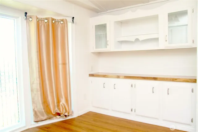 a view of a kitchen with wooden floor