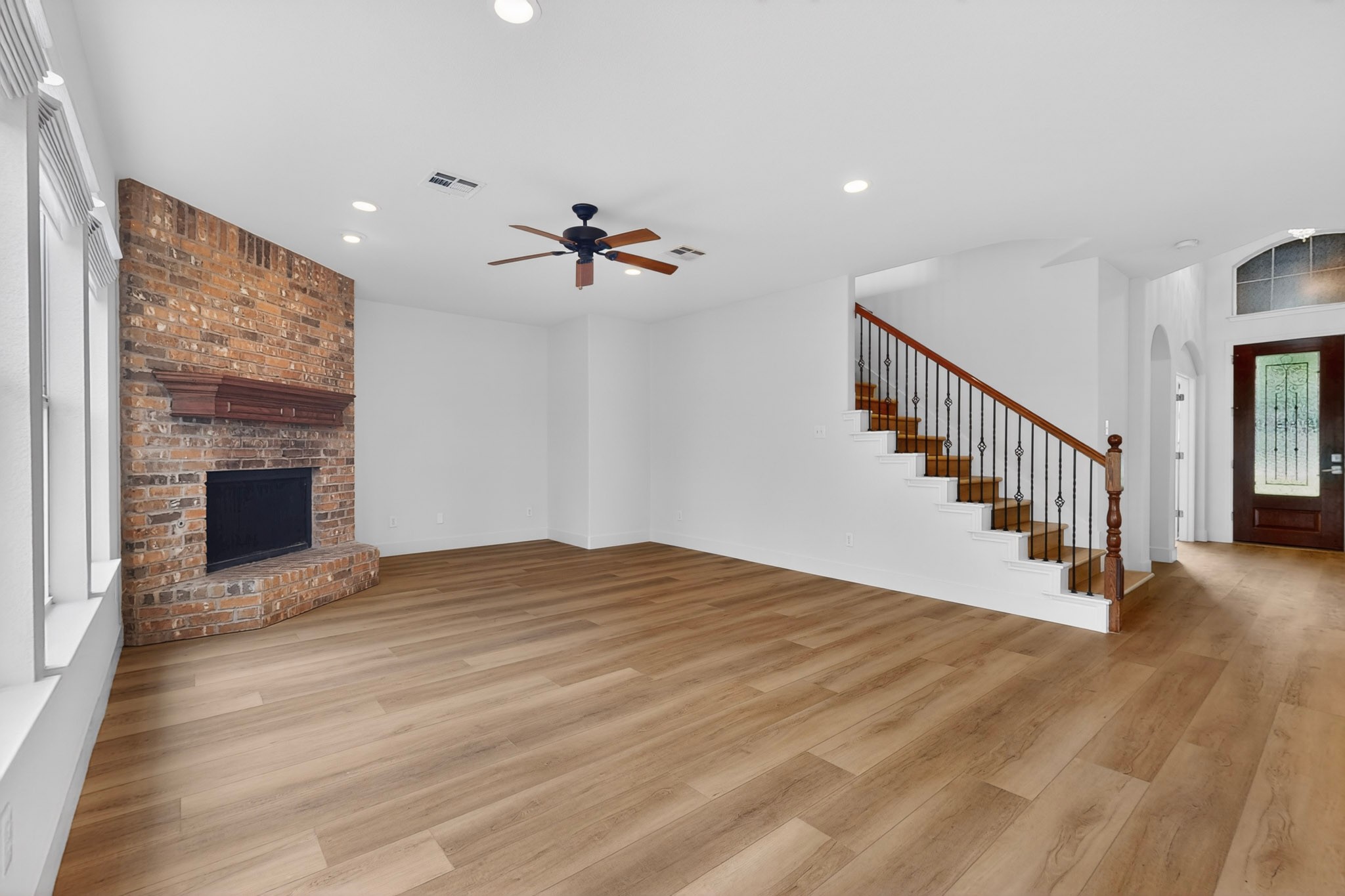 8617 Cobblestone Austin, TX 78735 - Photo 6 of 39 a view of an empty room with wooden floor fireplace and a window