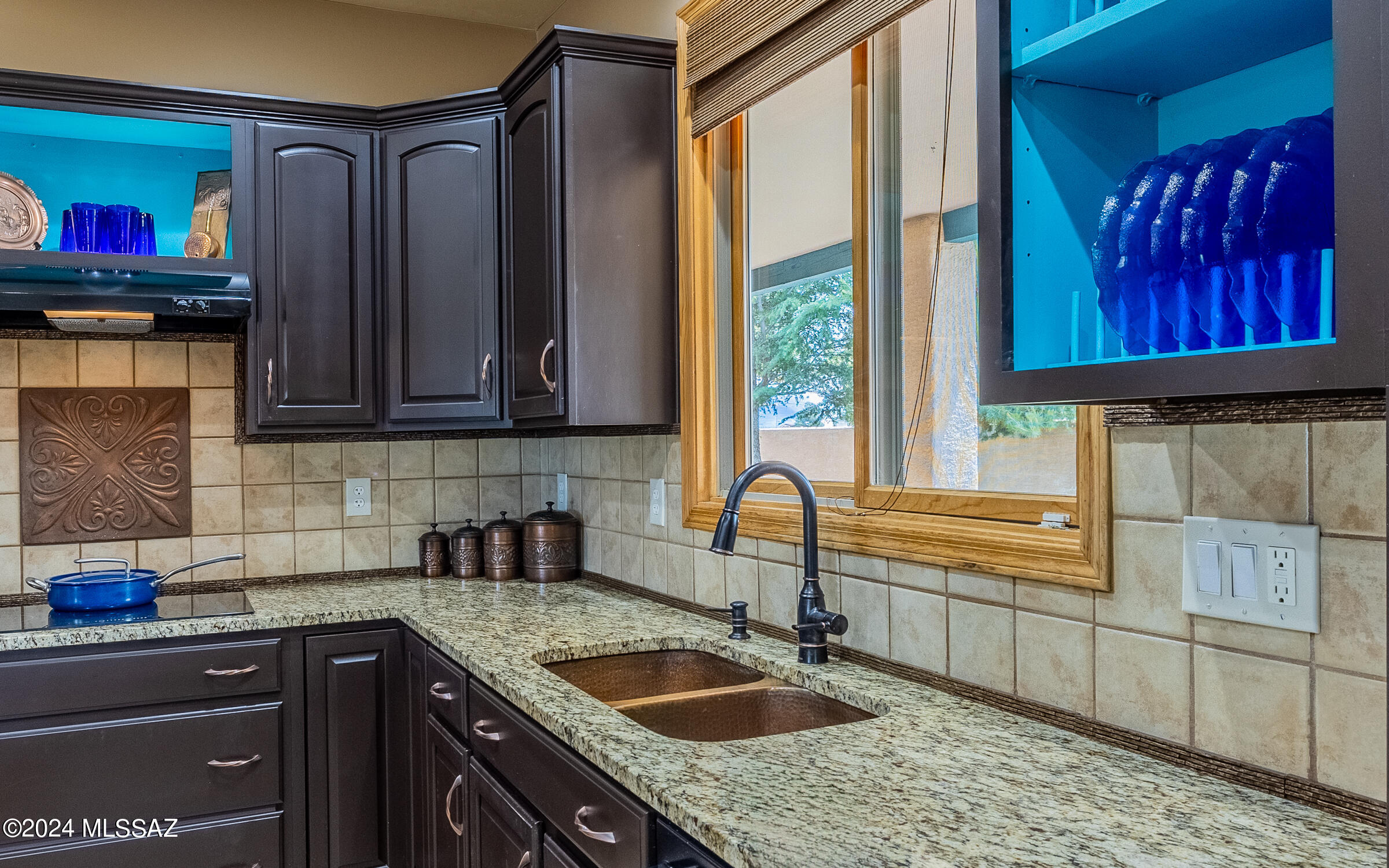 341 Sharon Road Vail, AZ 85641 - Photo 8 of 50 a kitchen with stainless steel appliances granite countertop a sink stove and wooden cabinets