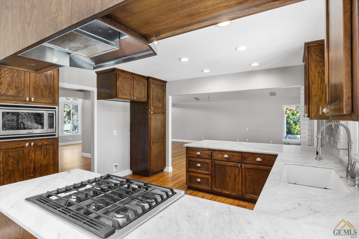 Undisclosed Address Bakersfield, CA 93308 - Photo 13 of 40 a kitchen with stainless steel appliances granite countertop a stove a sink and a refrigerator