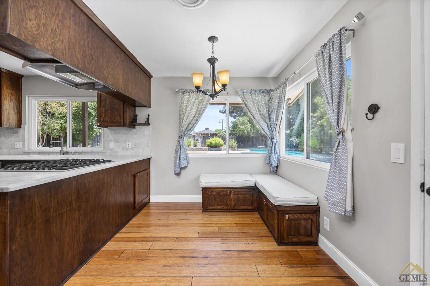 Undisclosed Address Bakersfield, CA 93308 - Photo 14 of 40 a view of living room kitchen with a sink appliances and furniture