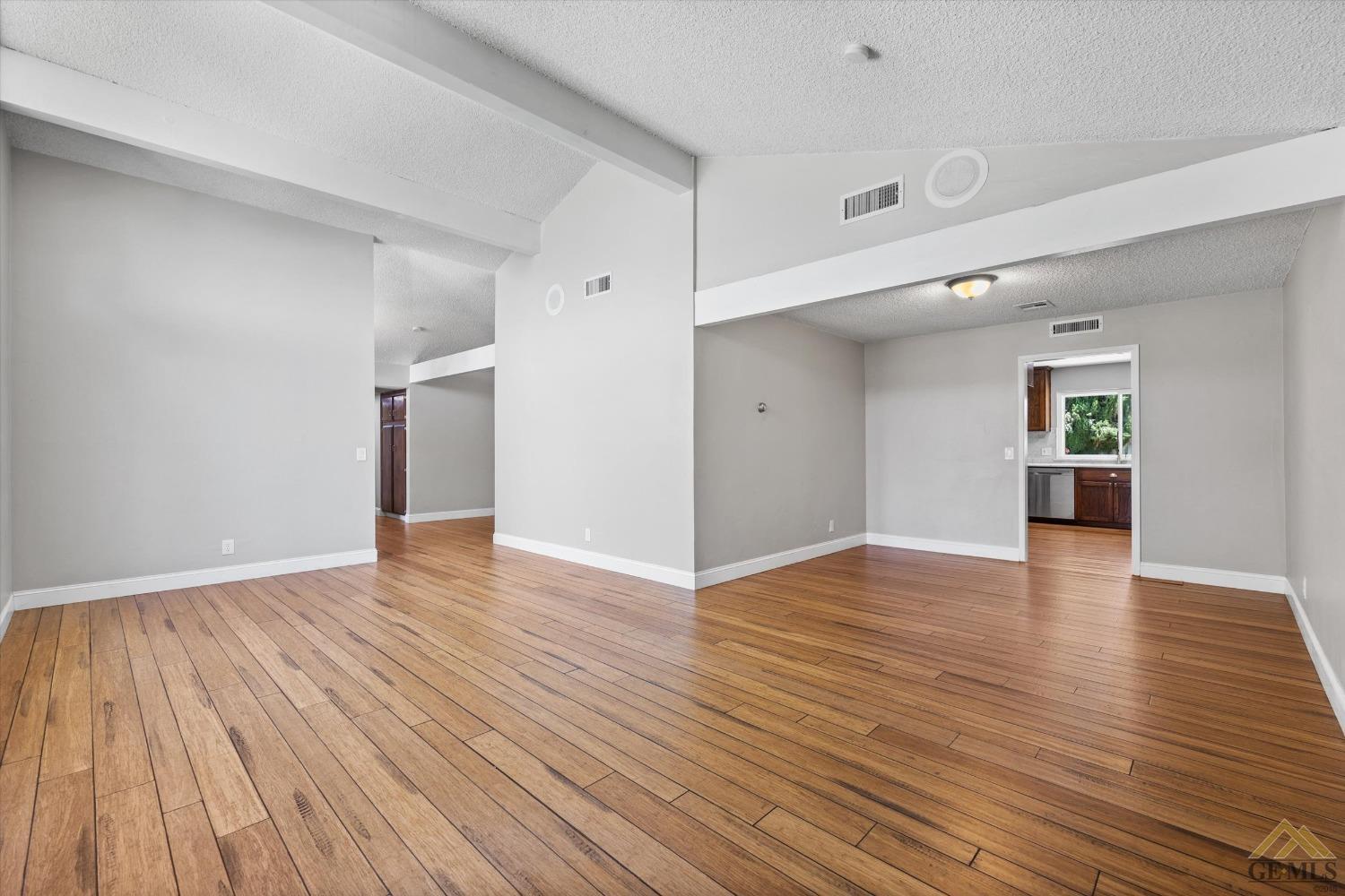 Undisclosed Address Bakersfield, CA 93308 - Photo 16 of 40 a view of an empty room with wooden floor