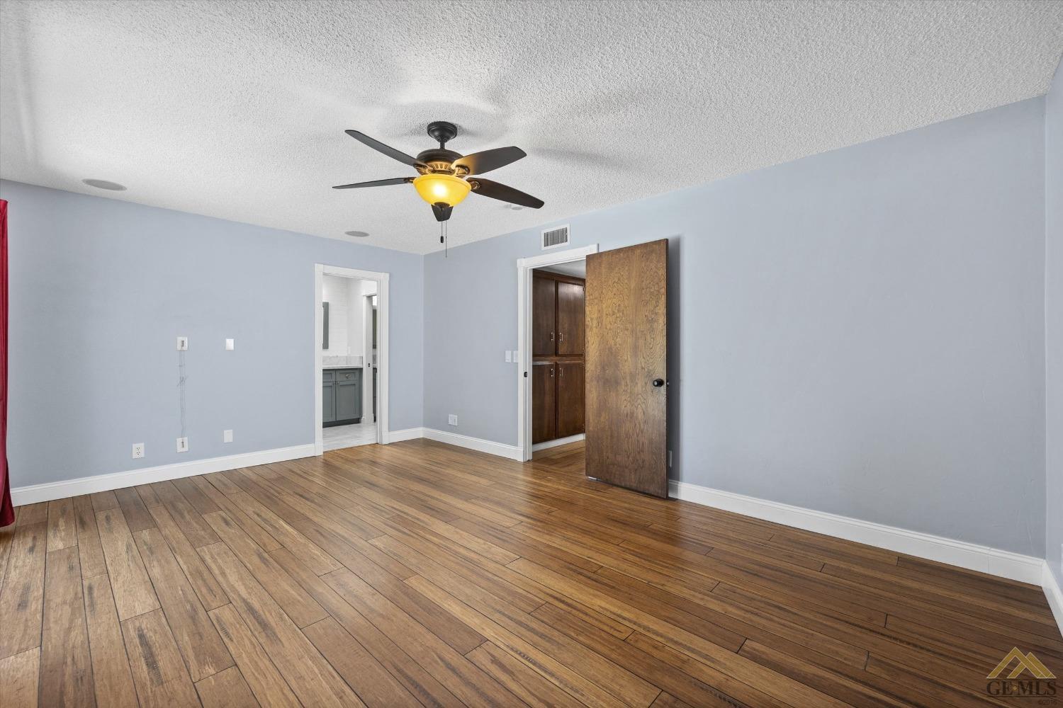 Undisclosed Address Bakersfield, CA 93308 - Photo 19 of 40 a view of an empty room with window and wooden floor