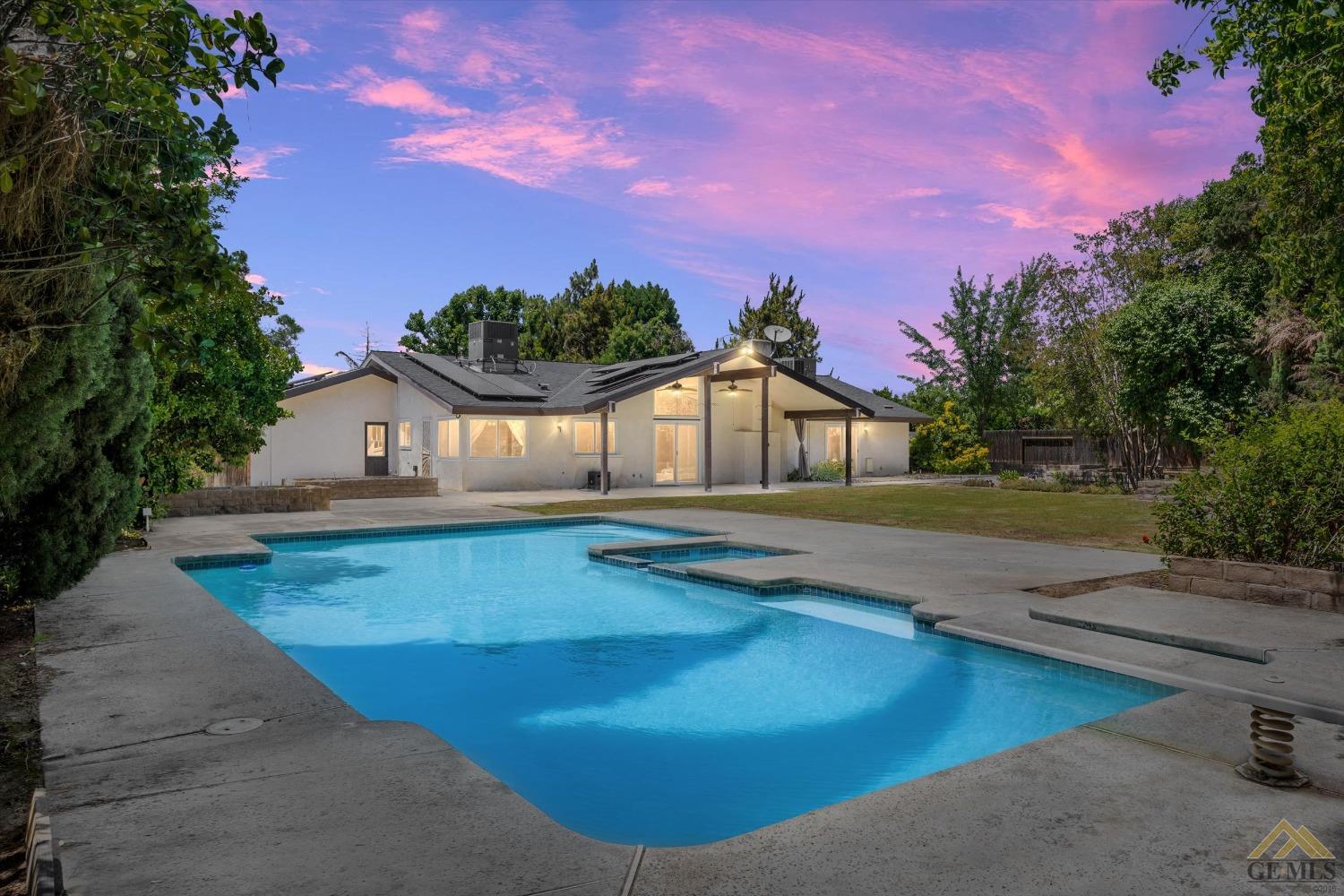 Undisclosed Address Bakersfield, CA 93308 - Photo 2 of 40 a view of a house with swimming pool and a yard
