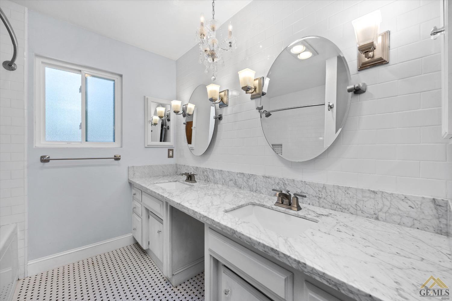 Undisclosed Address Bakersfield, CA 93308 - Photo 23 of 40 a en suite bathroom with a double vanity sink and a mirror