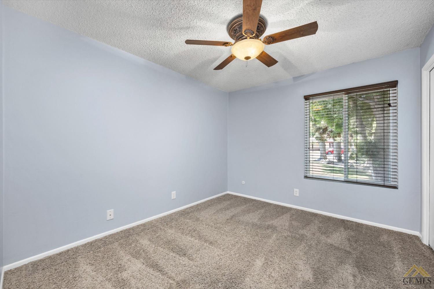 Undisclosed Address Bakersfield, CA 93308 - Photo 24 of 40 an empty room with a window and a fan