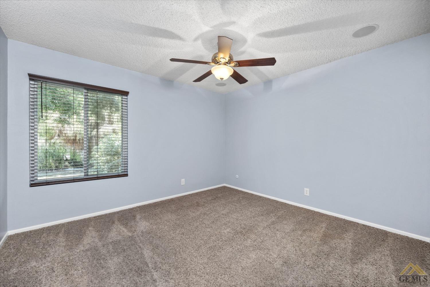 Undisclosed Address Bakersfield, CA 93308 - Photo 25 of 40 an empty room with a window and a fan