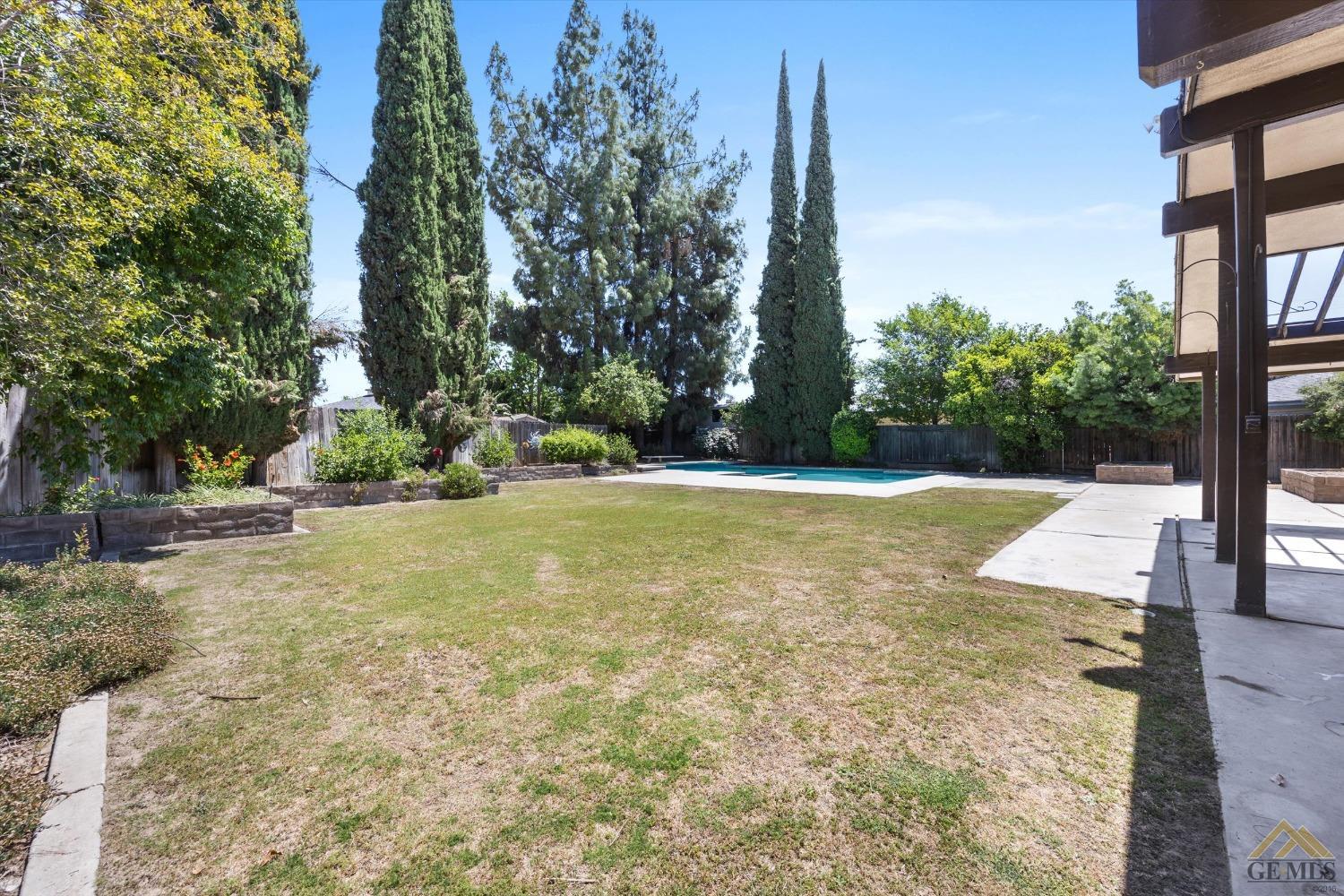 Undisclosed Address Bakersfield, CA 93308 - Photo 28 of 40 a view of a swimming pool with a yard
