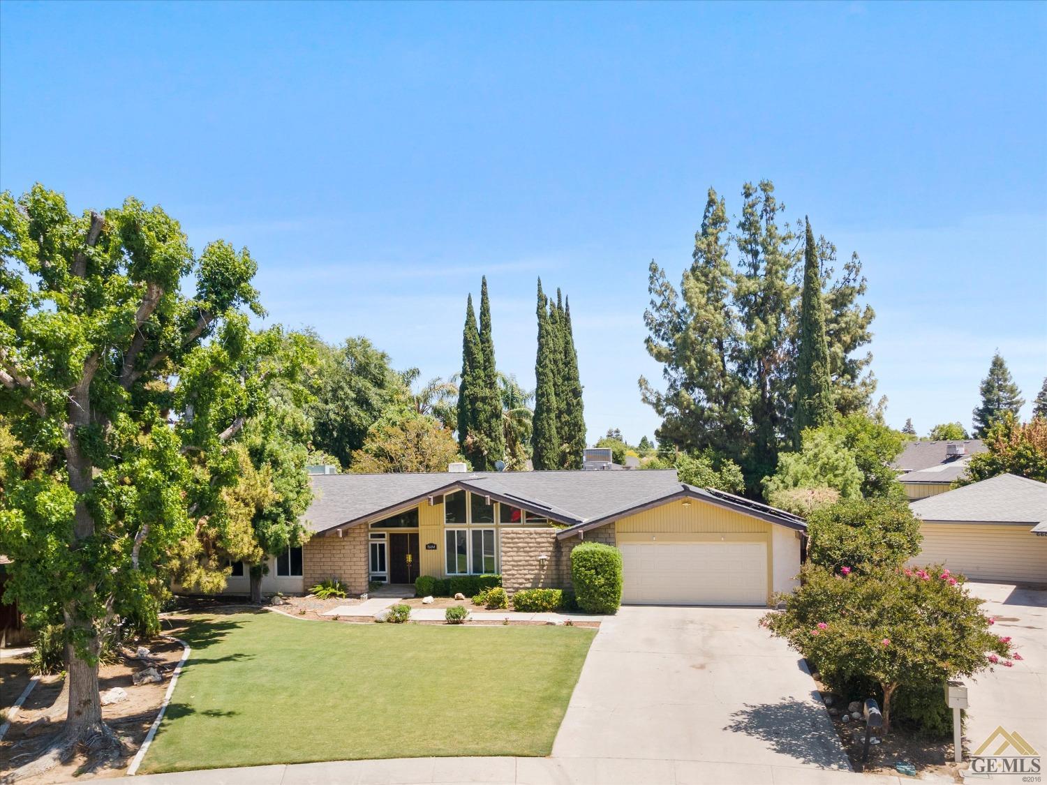 Undisclosed Address Bakersfield, CA 93308 - Photo 40 of 40 a front view of a house with a yard and trees