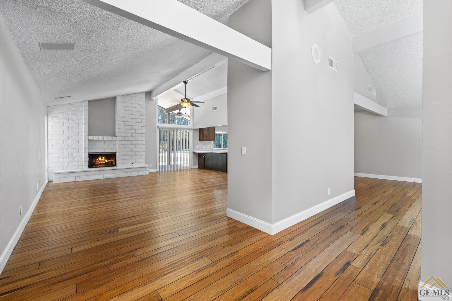 Undisclosed Address Bakersfield, CA 93308 - Photo 5 of 40 a view of a livingroom with furniture wooden floor and a fireplace