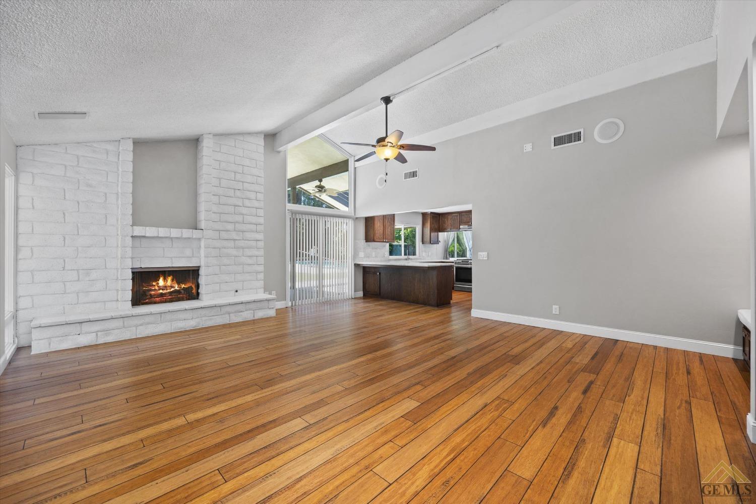 Undisclosed Address Bakersfield, CA 93308 - Photo 6 of 40 a view of empty room with wooden floor and fireplace