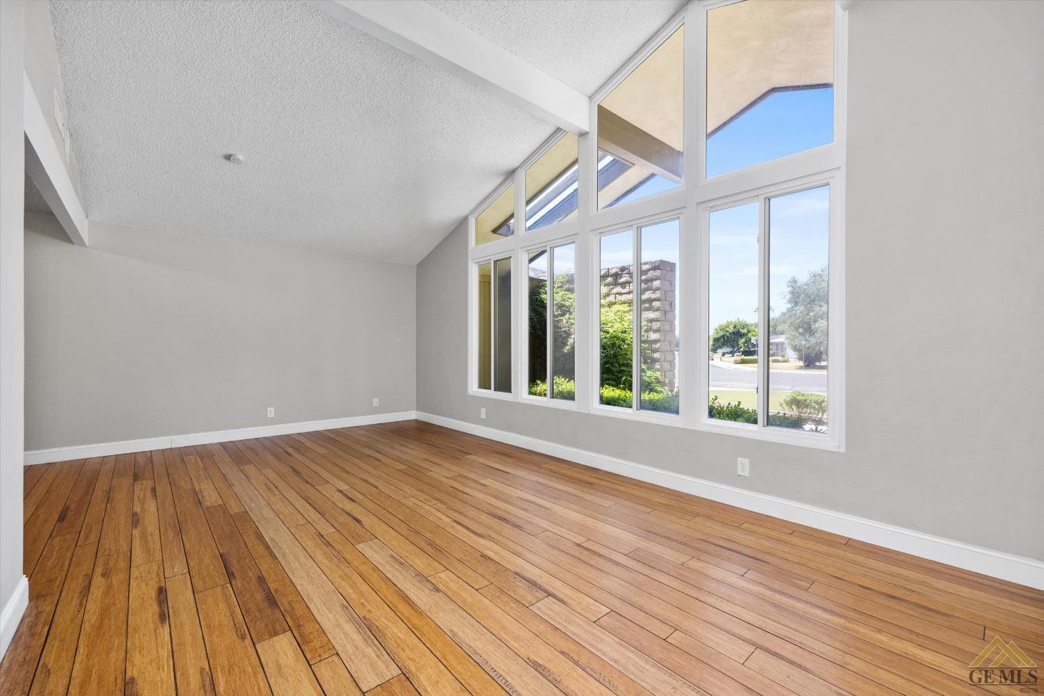 Undisclosed Address Bakersfield, CA 93308 - Photo 7 of 40 a view of an empty room with wooden floor and a window