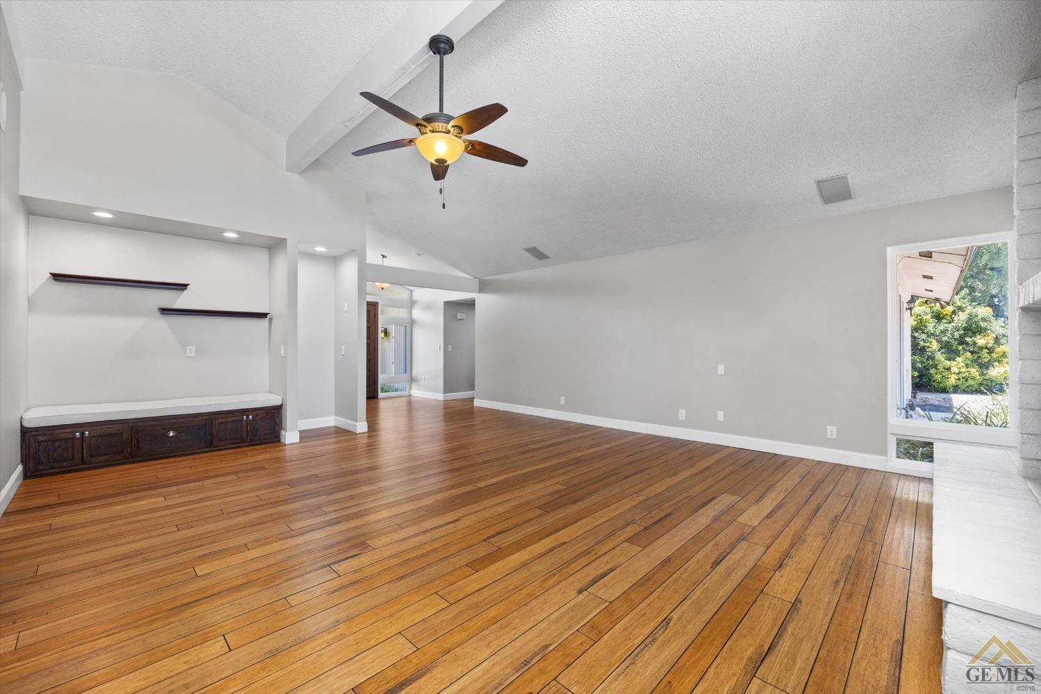 Undisclosed Address Bakersfield, CA 93308 - Photo 10 of 40 a view of a room with wooden floor and ceiling fan