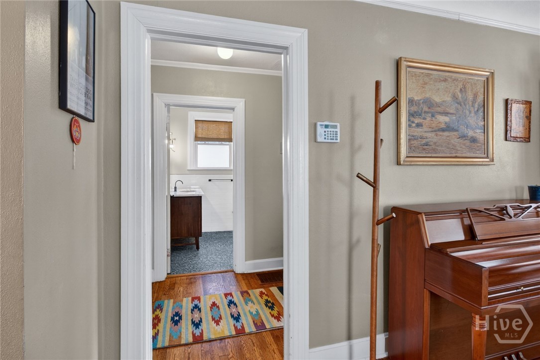 512 East 58th Street Savannah, GA 31405 - Photo 14 of 44 Hallway leading to bedrooms downstairs with view of full bathroom