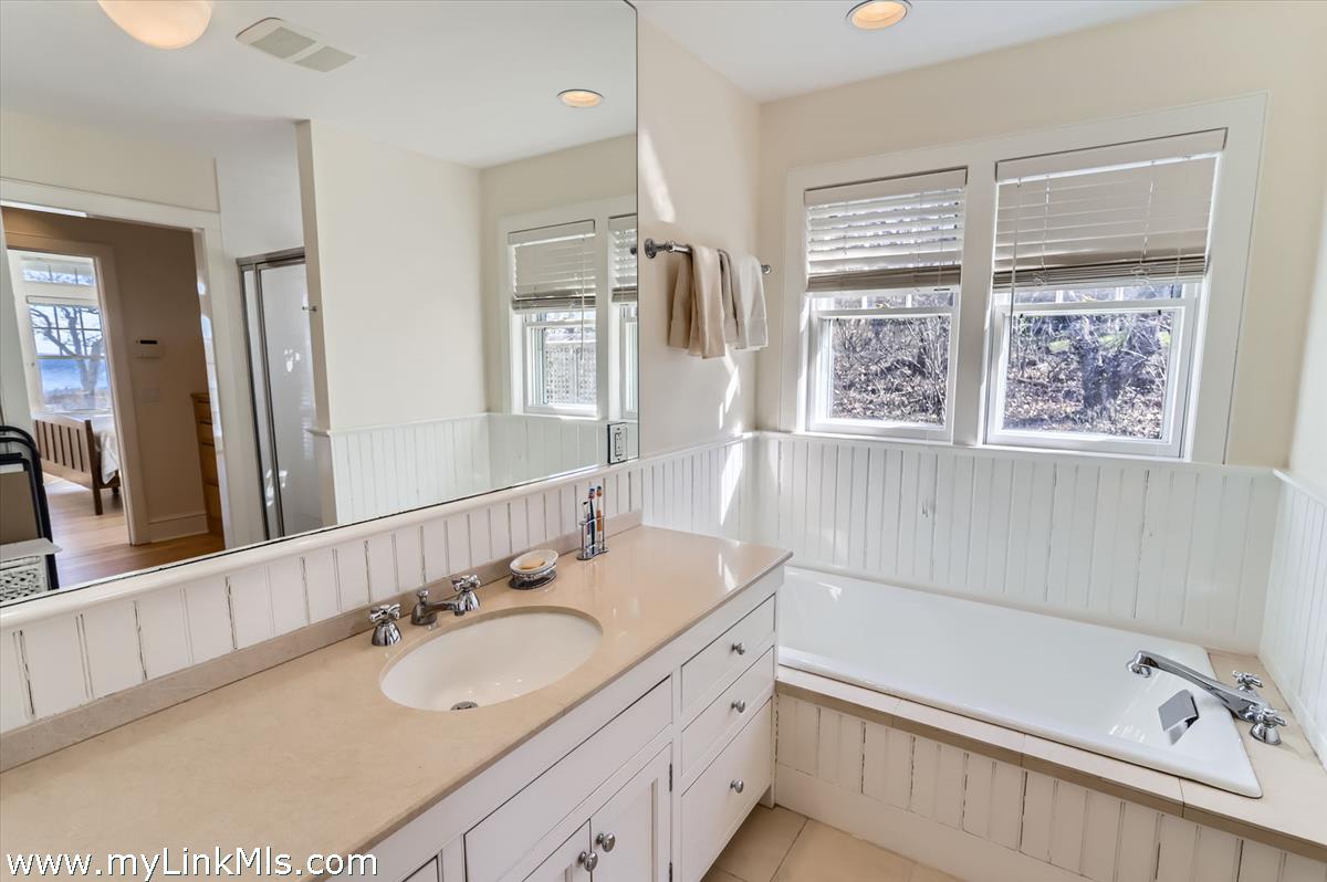 78 Hammett Road Chilmark, MA 02535 - Photo 25 of 53 a bathroom with a granite countertop sink mirror and a bathtub
