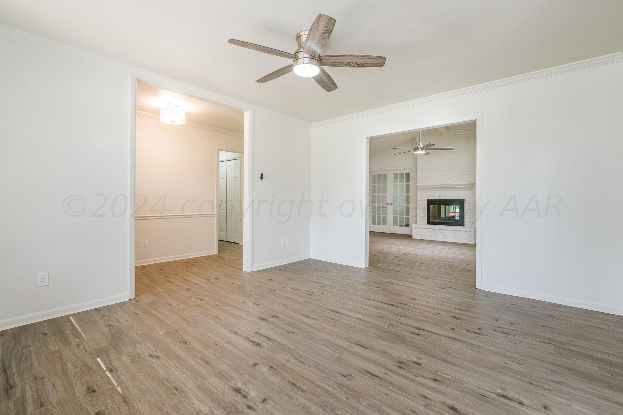 7220 Montague Drive Amarillo, TX 79109 - Photo 14 of 29 a view of empty room with wooden floor and ceiling fan
