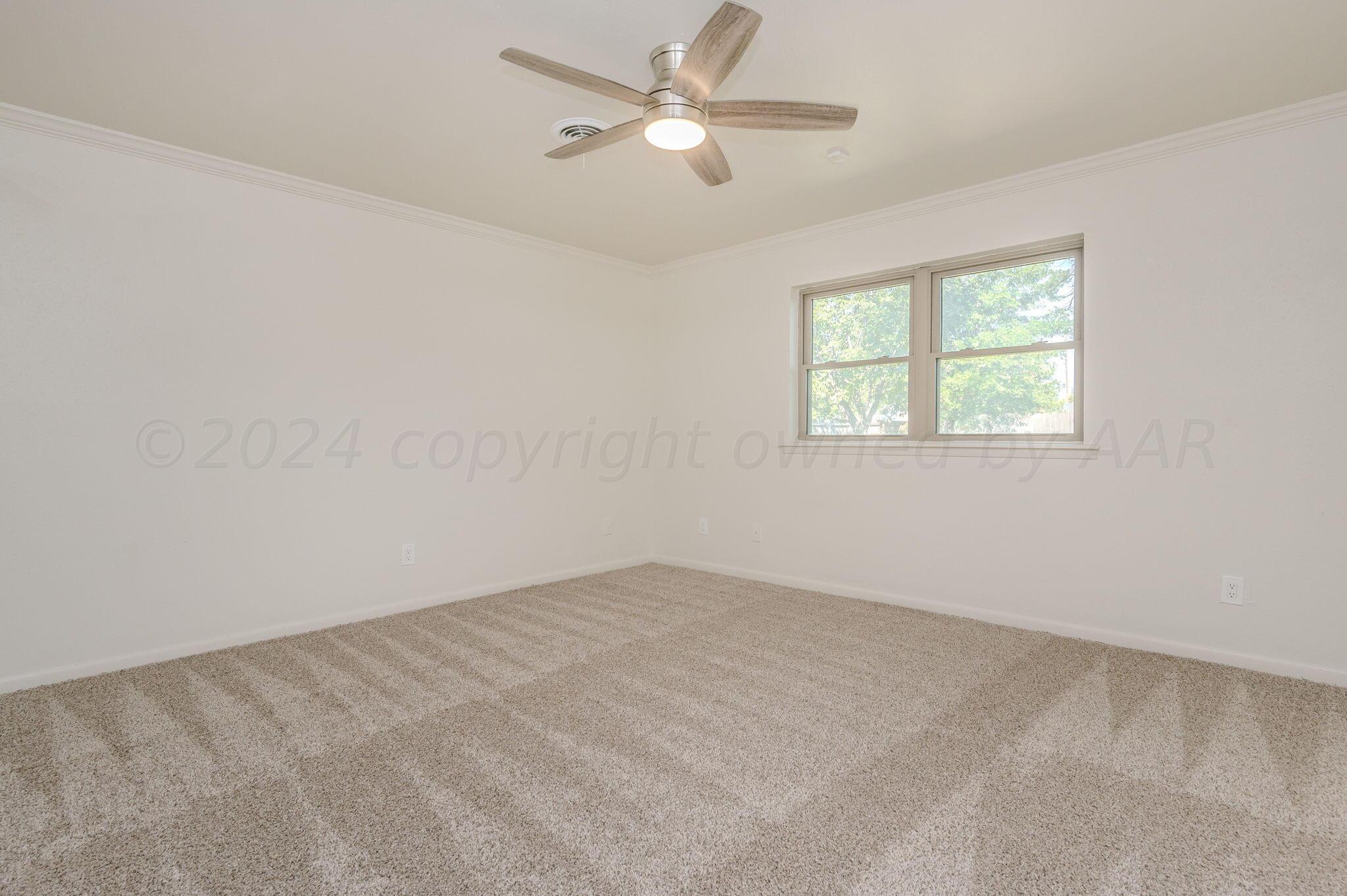 7220 Montague Drive Amarillo, TX 79109 - Photo 15 of 29 an empty room with a window and a fan