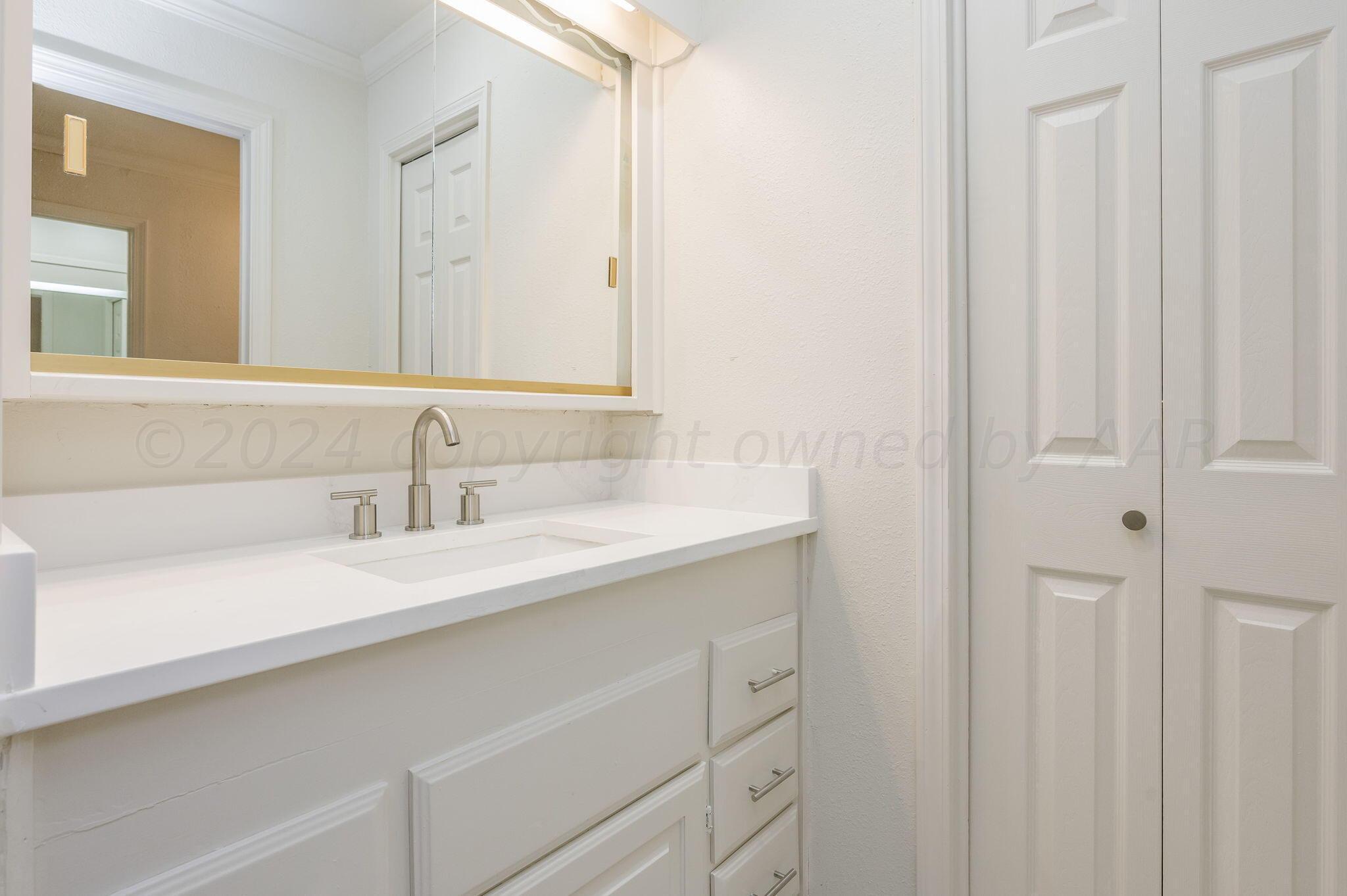 7220 Montague Drive Amarillo, TX 79109 - Photo 17 of 29 a bathroom with a sink and a mirror