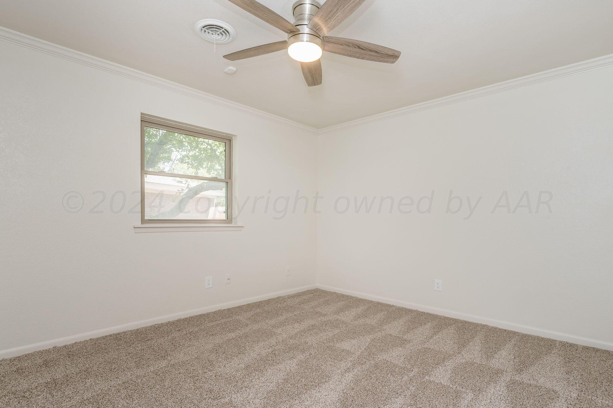 7220 Montague Drive Amarillo, TX 79109 - Photo 20 of 29 an empty room with a window and a fan
