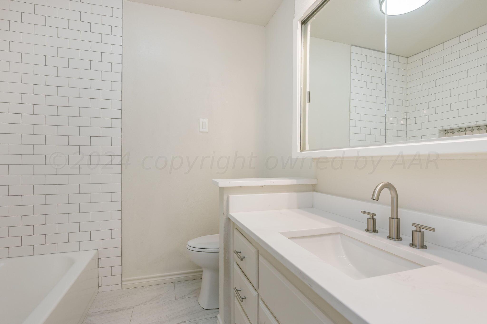 7220 Montague Drive Amarillo, TX 79109 - Photo 21 of 29 a bathroom with a sink a toilet and shower