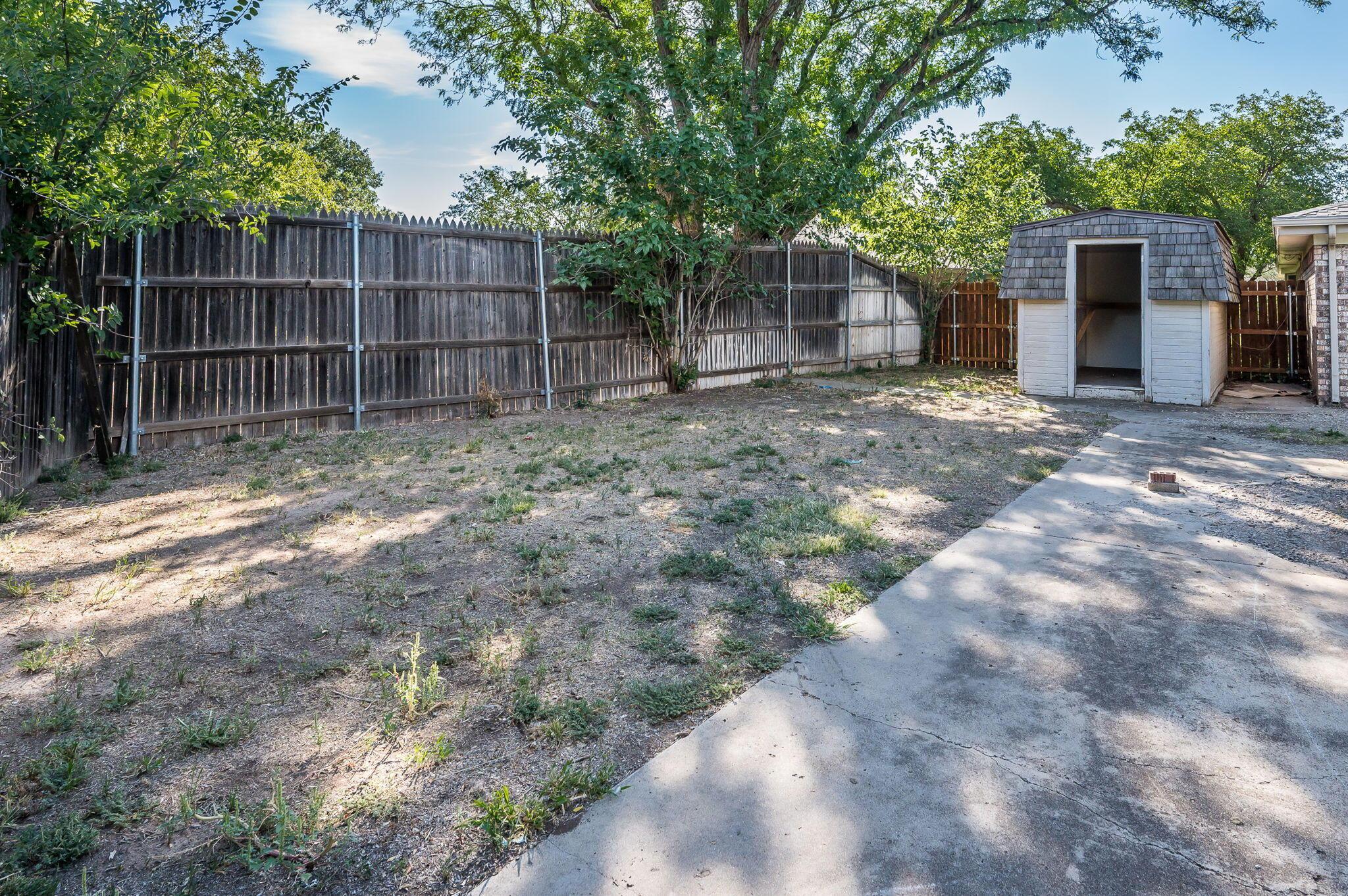 7220 Montague Drive Amarillo, TX 79109 - Photo 27 of 29 a view of a backyard with plants and large trees