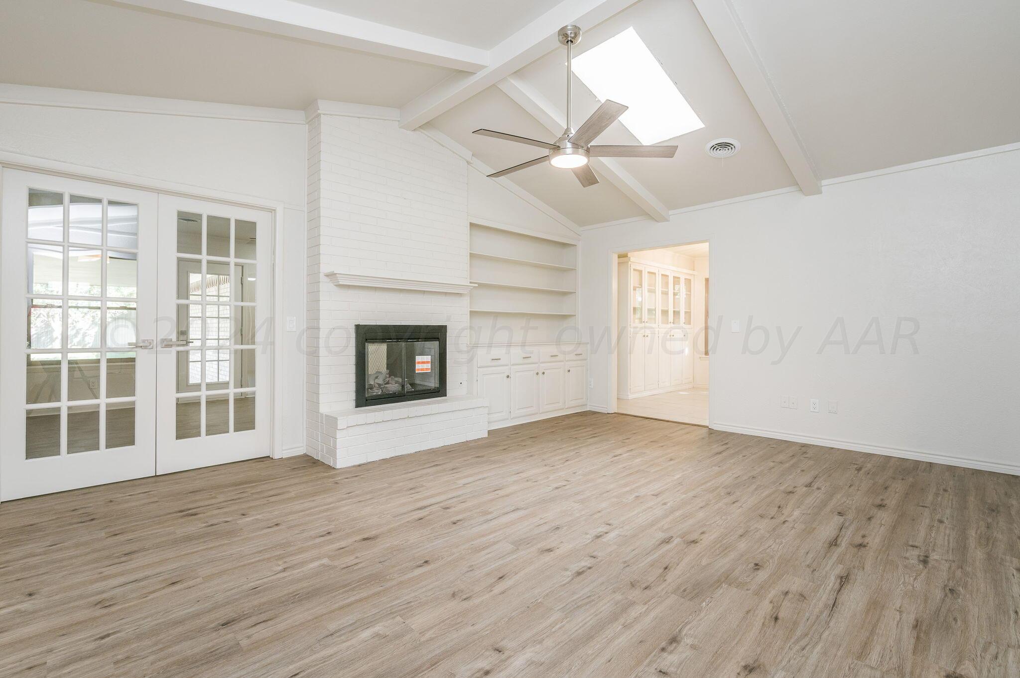 7220 Montague Drive Amarillo, TX 79109 - Photo 8 of 29 an empty room with wooden floor fan and windows