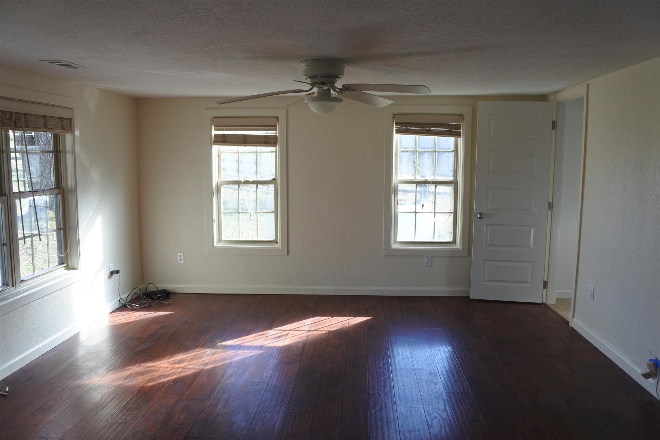 375 Lonesome Valley Road Allons, TN 38541 - Photo 9 of 23 a view of an empty room with wooden floor and a window