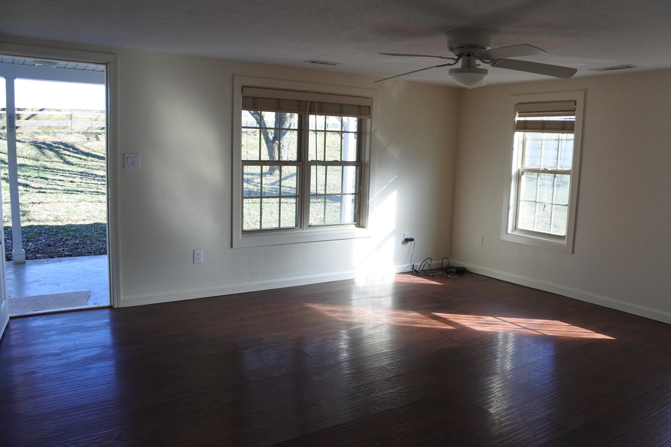 375 Lonesome Valley Road Allons, TN 38541 - Photo 10 of 23 a view of an empty room with wooden floor and a window