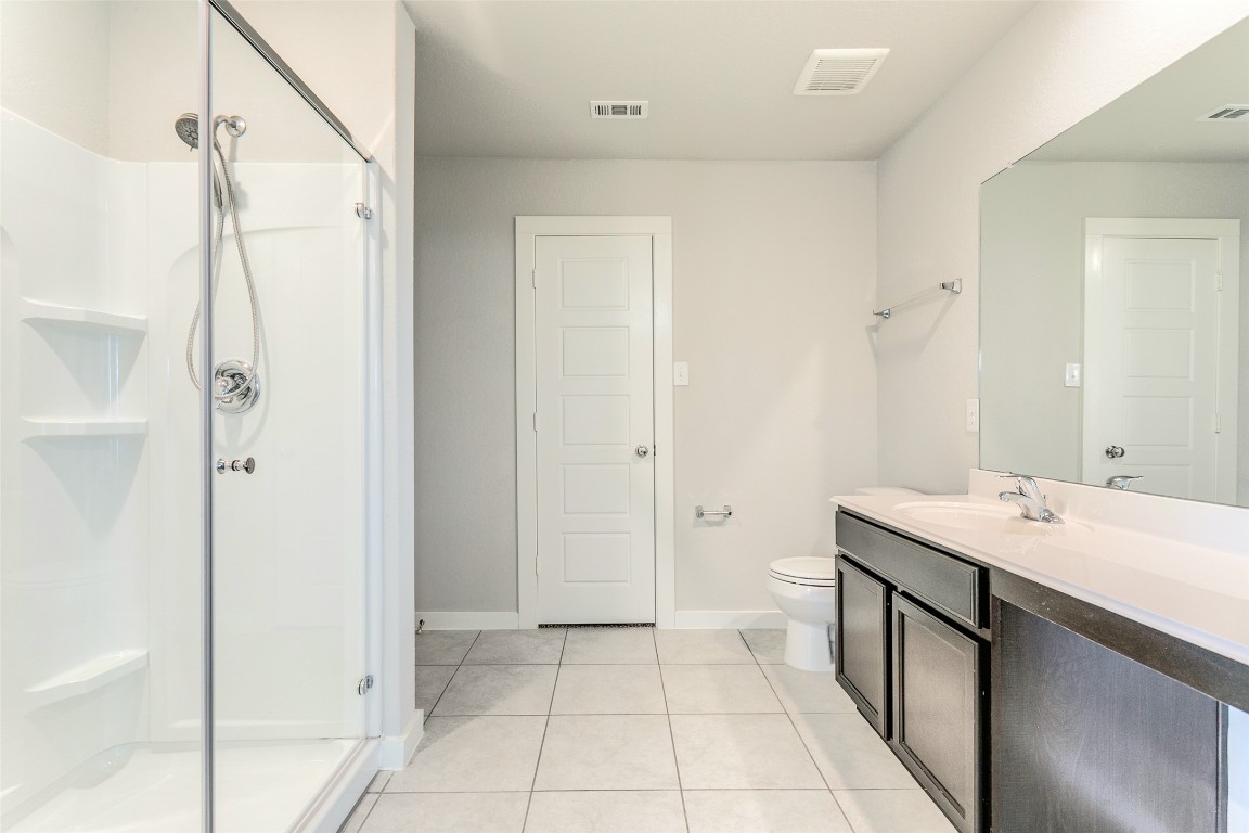 9111 Spigel Way Converse, TX 78109 - Photo 7 of 13 a spacious bathroom with a double vanity sink a mirror and a shower
