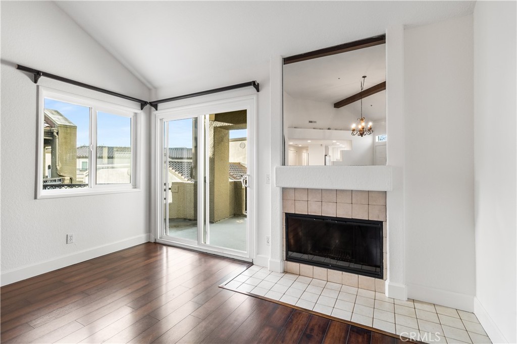 430 Lake Street, Unit 304 Huntington Beach, CA 92648 - Photo 11 of 46 an empty room with wooden floor a fireplace and windows