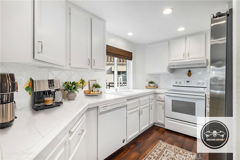 430 Lake Street, Unit 304 Huntington Beach, CA 92648 - Photo 2 of 46 a kitchen with cabinets and window