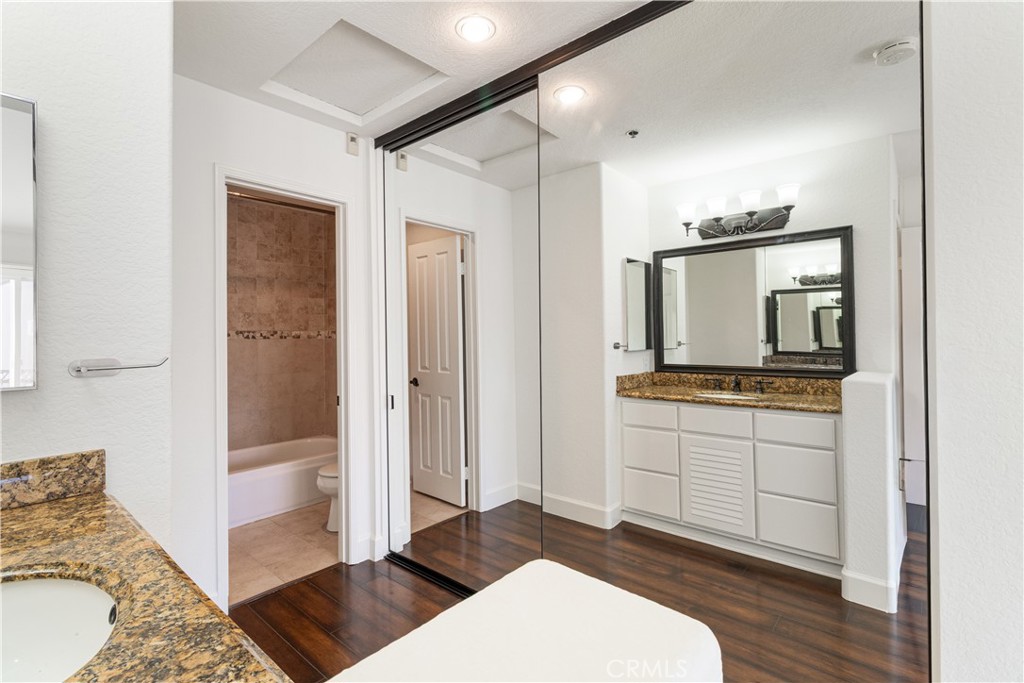 430 Lake Street, Unit 304 Huntington Beach, CA 92648 - Photo 34 of 46 a room with a bed and a view of bathroom